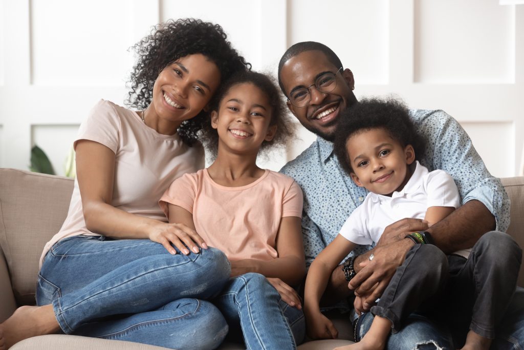 Portrait of African American family with kids relax on couch